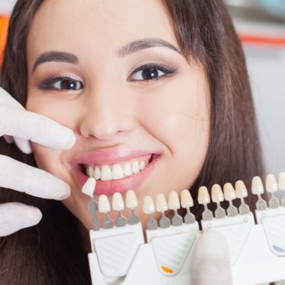 Smiling young woman getting veneers from her cosmetic dentist in Mercerville