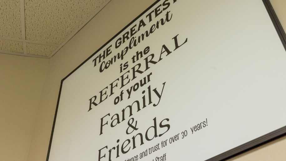 Wall sign that reads the greatest compliment is the referral of your family and friends