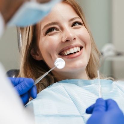 Woman smiling at her dentist during a preventive dentistry checkup