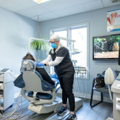 Dental team member examining a patient