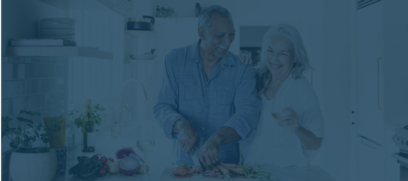 Man and woman cooking in their kitchen after getting dental implants in Mercerville