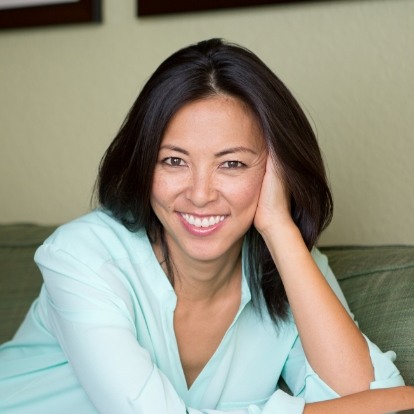 Woman in mint green blouse smiling