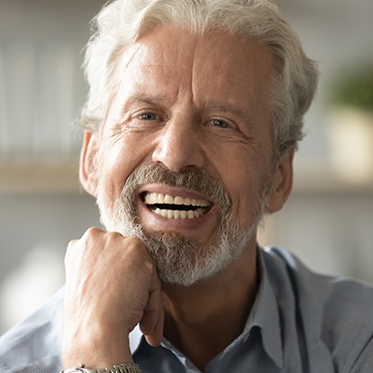 a closeup of a denture patient smiling