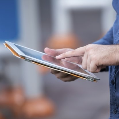 Person typing on a tablet