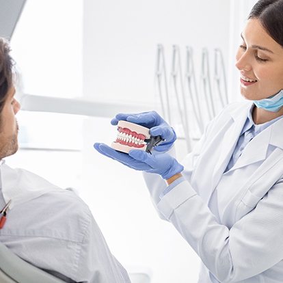 Young man listening to female dentist