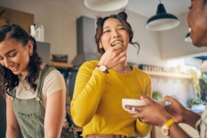 Woman eating food after dental implant surgery