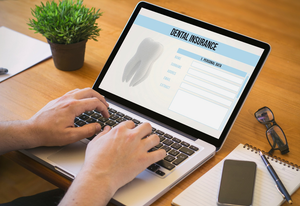 a patient filling out a dental insurance form
